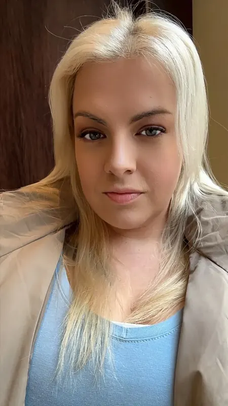 Elise Muse in a light blue top and beige jacket